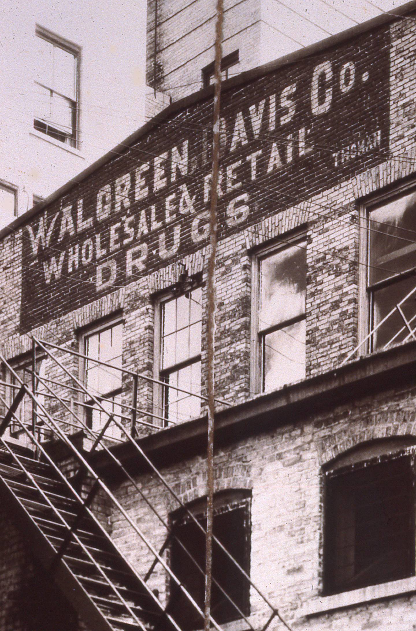 This photo, taken around 1939, shows the back (south) side of the Walgreen-Davis building. The sign is still faintly visible today from Commercial Alley and the Beanblossom parking lot.