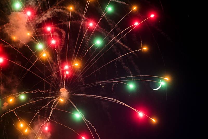 A sliver of a moon shines through the colorful explosions of the Jaycees fireworks show Friday, July 1, 2022 over Sterling-Rock Falls.