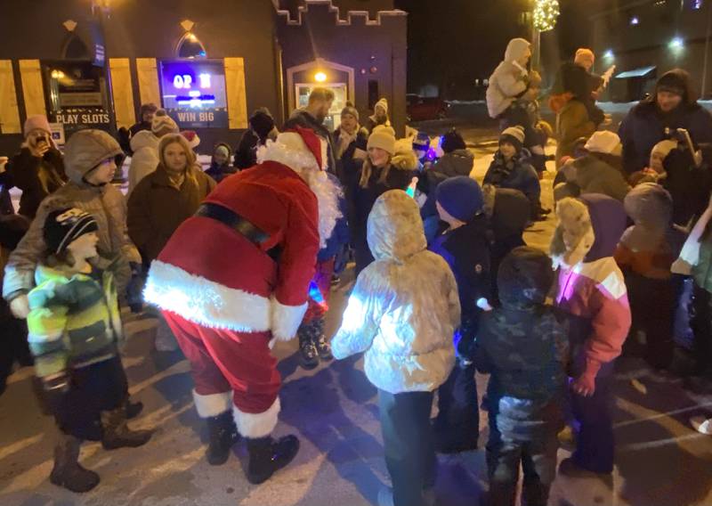 Santa Claus greets waiting children eager to tell him what they want for Christmas on Friday, Dec. 5, 2025, at the Sycamore Chamber of Commerce's annual Walk with Santa in downtown Sycamore.