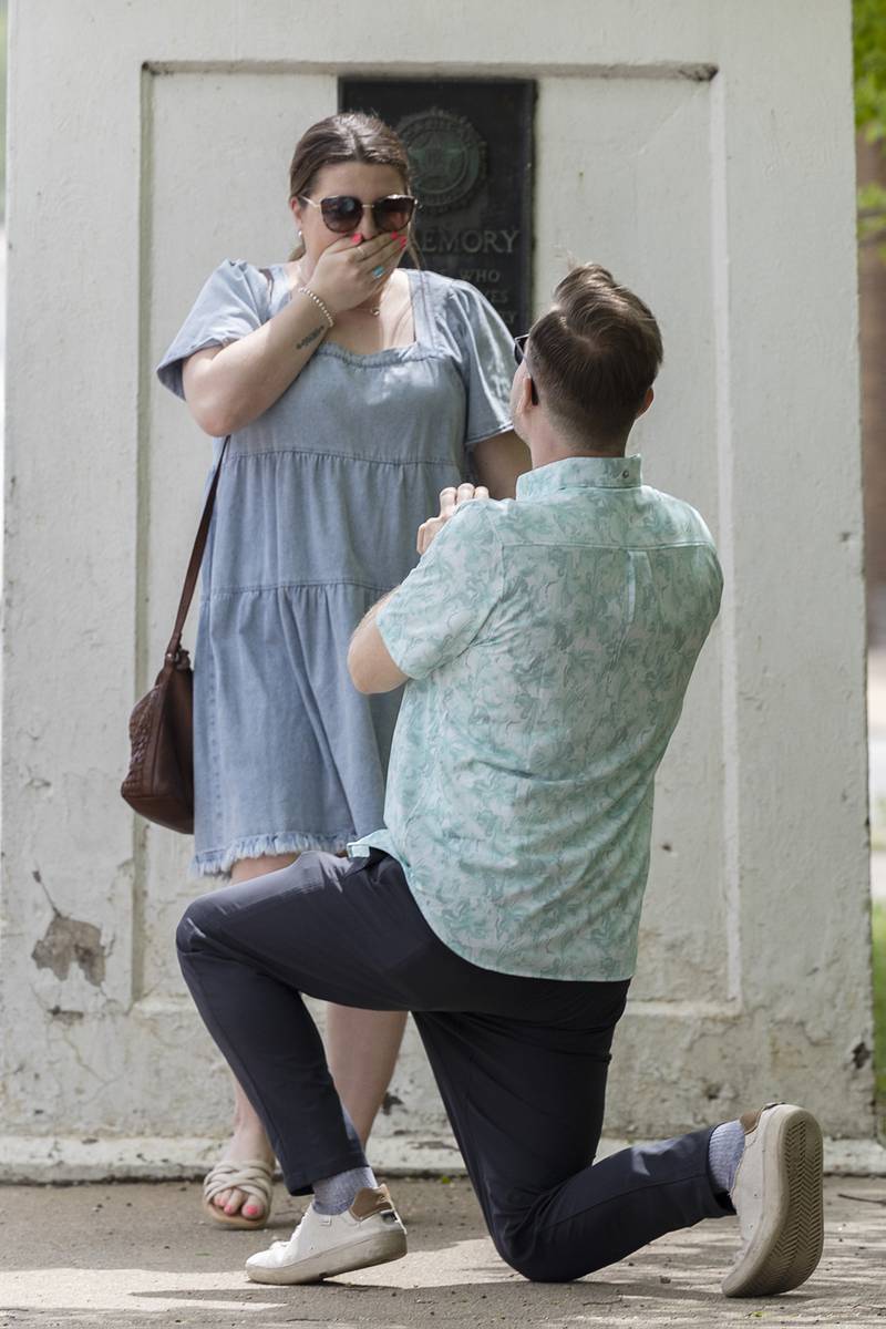 Emma Walsh reacts to being proposed to by Riley Dixon Saturday, April 27, 2024, just below the Dixon arch.