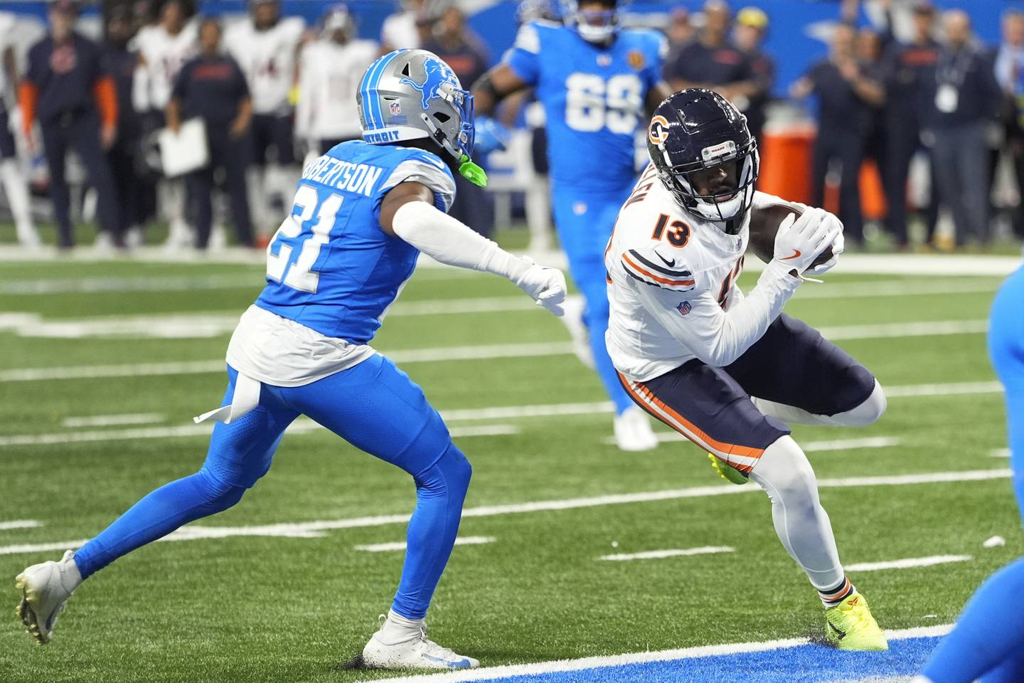 Chicago Bears wide receiver Keenan Allen (13) scores on a touchdown reception as Detroit Lions cornerback Amik Robertson (21) defends during the second half of an NFL football game, Sunday, Nov. 17, 2024, in Detroit. (AP Photo/Carlos Osorio)