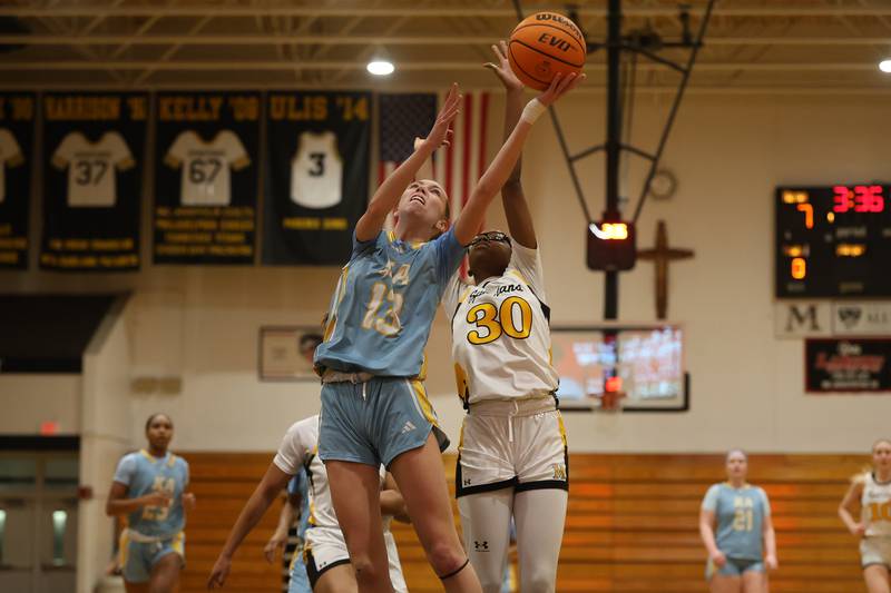 Joliet Catholic’s Abigail Dulinsky lays in a contested shot against Marian Catholic on Wednesday, Jan. 14, 2026 in Chicago Heights.