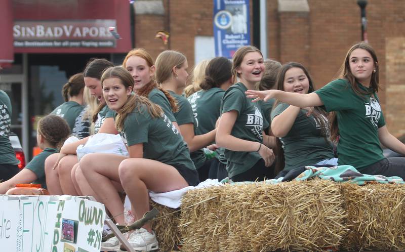 St. Bede volleyball players ride on a a float during the St. Bede Homecoming parade on Friday, Sept. 27, 2024 downtown Peru.