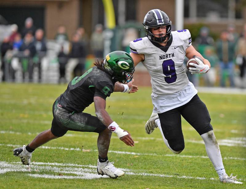 Downers Grove North’s William Vala (right) tries to get past Glenbard West’s Jaylen McMiller during a Class 7A second-round playoff game on November 8, 2025 at Glenbard West High School in Glen Ellyn.