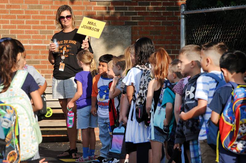 First-grade teacher Georgia Johnson lines up her students on the first day of school at Haskin Elementary in Sandwich on Wednesday, Aug. 17, 2023.