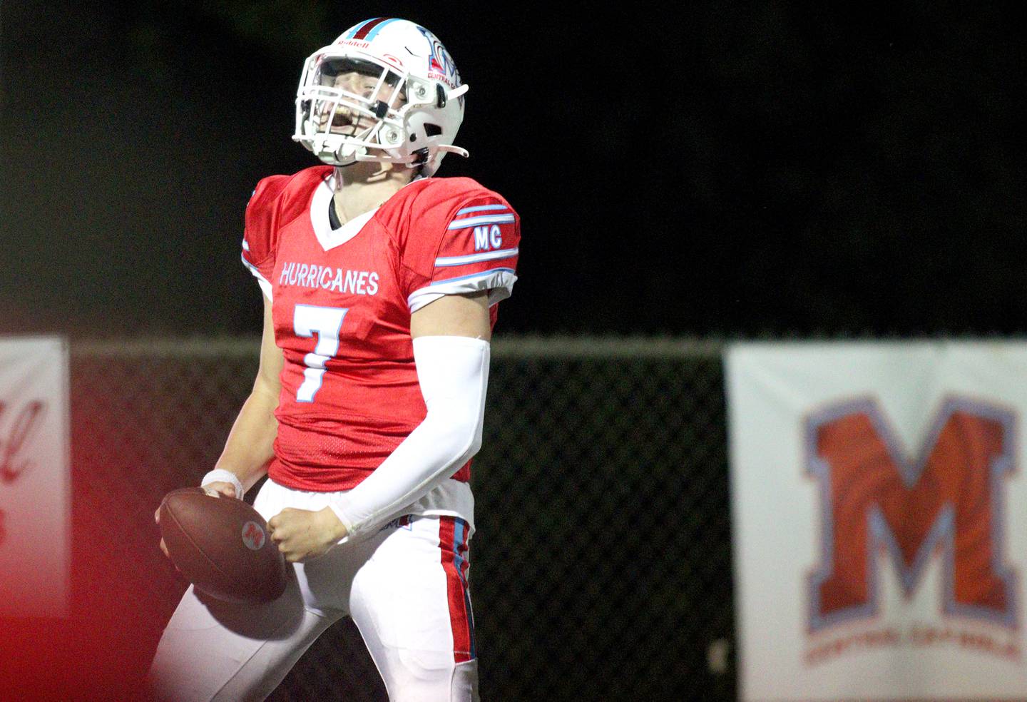 Marian Central’s Cale McThenia celebrates a touchdown against Chicago Hope in varsity  football  at Woodstock Friday night.