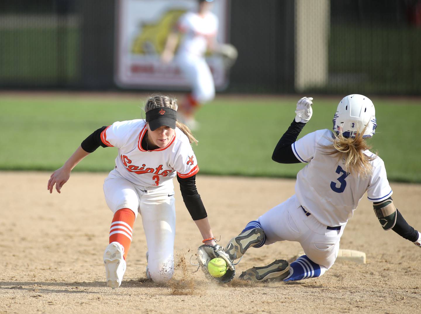 St. Charles East’s Abby Arend (left) is unable to get St. Charles North’s Leigh VanderHei out at second base during a game at St. Charles North on Monday, April 24. 2023.