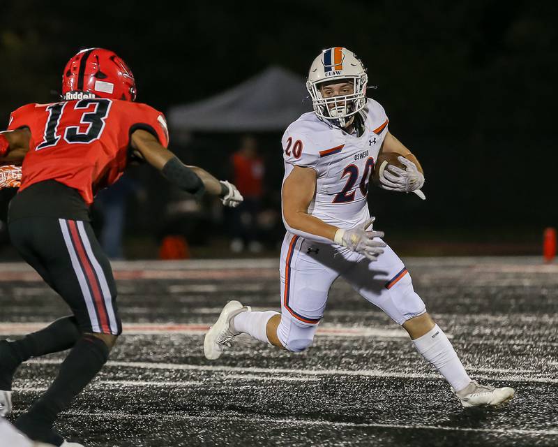 Oswego's Dylan King (20) looks for running room during a football game between Oswego at Bolingbrook on Friday, Oct 4th, 2024  in Bolingbrook.