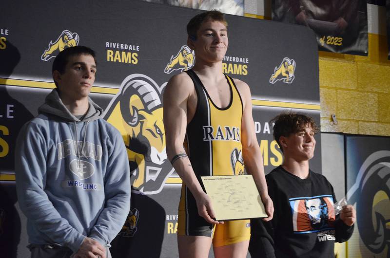 Riverdale's Brock Smith (middle) smiles atop the podium after winning the 138-pound title at the 1A Riverdale Regional on Saturday, Feb. 4, 2023. Newman's Carter Rude (left) placed second, and Rockridge's Bryan Blumenstein (right) took third.