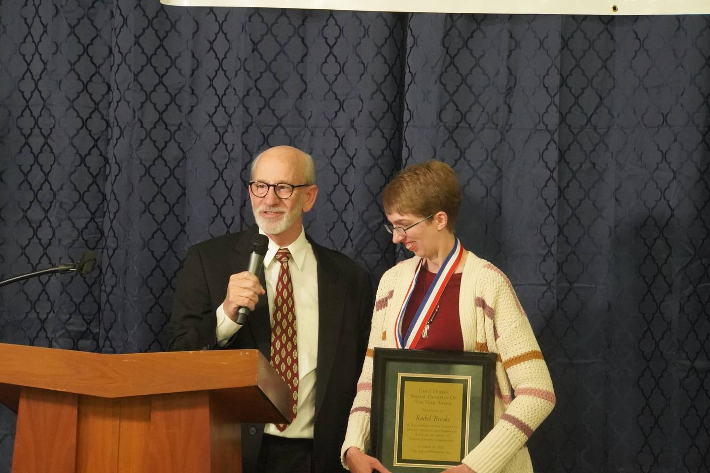 Rachel Brooks received the Carly Heller Special Olympian of the Year award at the Village of Progress Annual Banquet on Wednesday, Oct. 22, 2025 in Oregon. At left is Master of Ceremonies Tom Wadsworth.