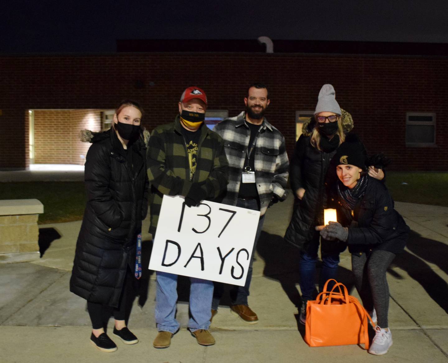 Four Sycamore High School teachers, pictured, joined a crowd of more than 300 people that attended a candlelight vigil on Tuesday, Dec. 14, 2021, outside Sycamore Middle School because the Sycamore Education Association and Sycamore School District 427 have still not yet agreed upon a contract. The contract expired July 31.