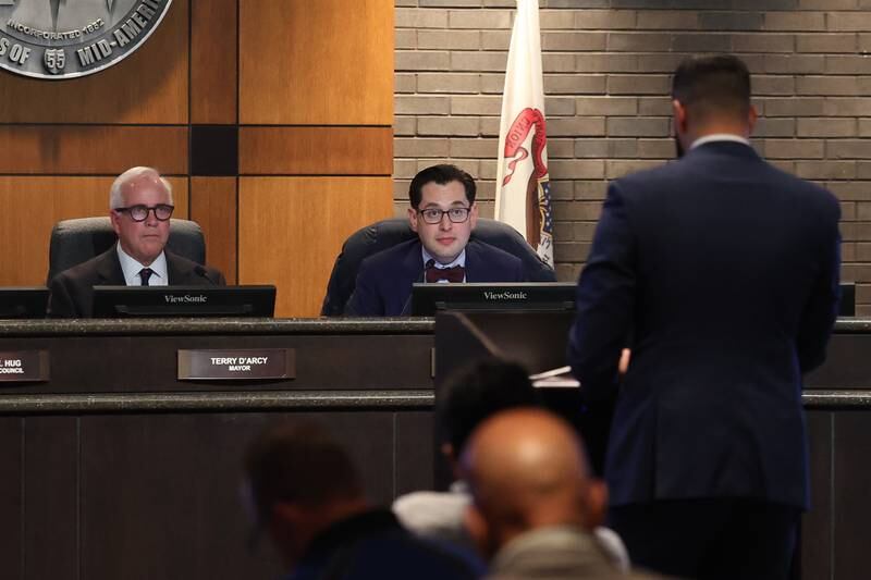 Joliet Mayor Terry D’Arcy and lawyer Ross Secler listen to Lawyer Karman Bains, representing John Dillan, as he goes over documents challenging four city council candidates for April 1 election a special Joliet Electoral Board meeting at Joliet City Hall on Tuesday, Dec. 3, 2024 in Joliet.