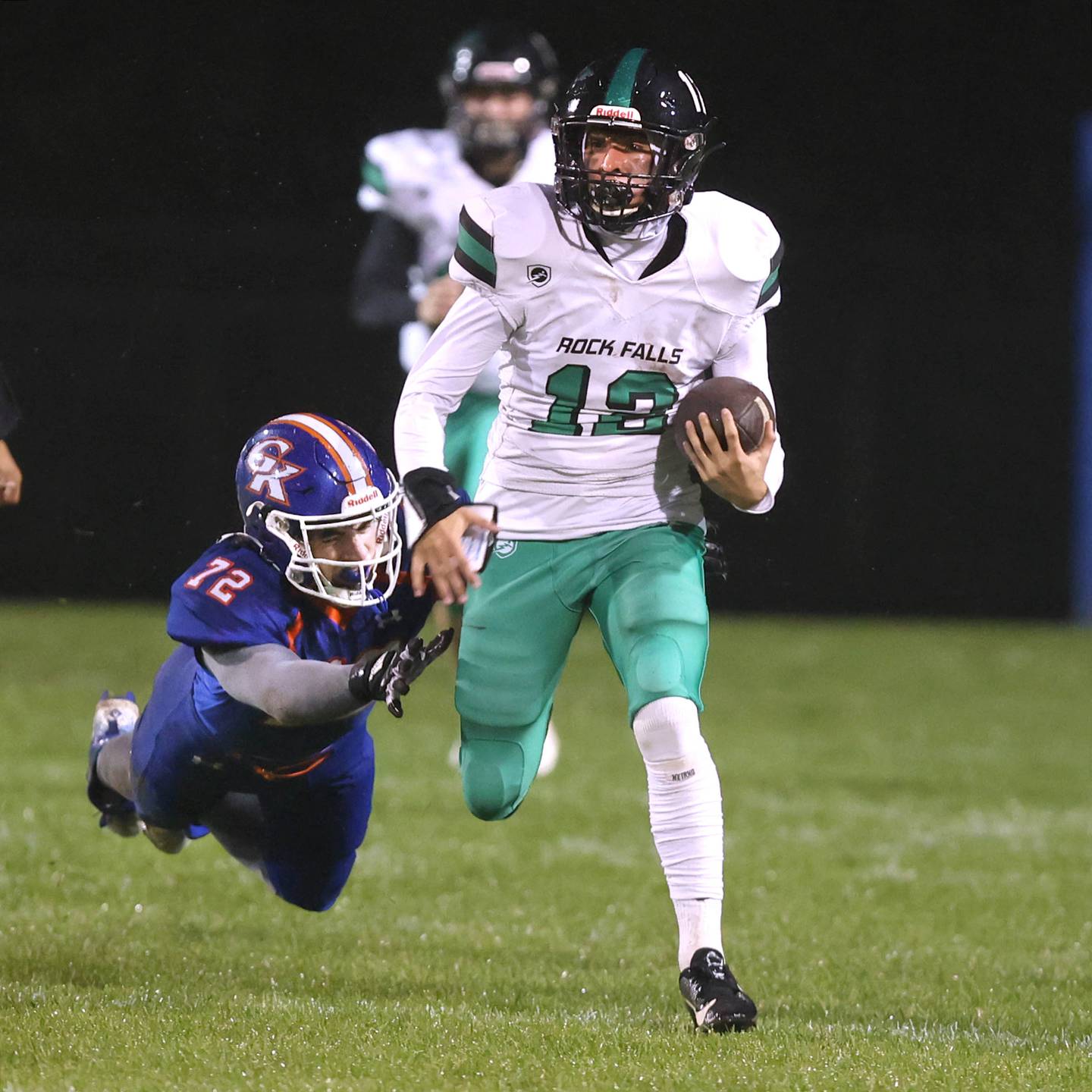 Rock Falls' Austin Castaneda gets by a diving Genoa-Kingston's Xander Gleissner as he returns the opening kickoff for a touchdown during their game Friday, Oct. 13, 2023, at Genoa-Kingston High School.