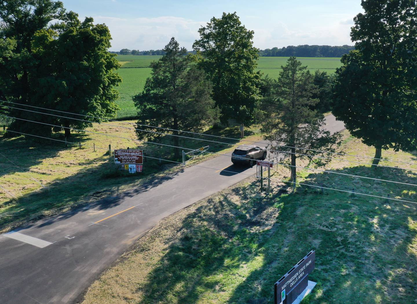 A vehicle drives on the new entrance road to Matthiessen State Park on Tuesday, Aug. 16, 2022 in Oglesby. Crews paved the parking lot and entrance road to Illinois Route 178. A sidewalk was also added along the entrance road.