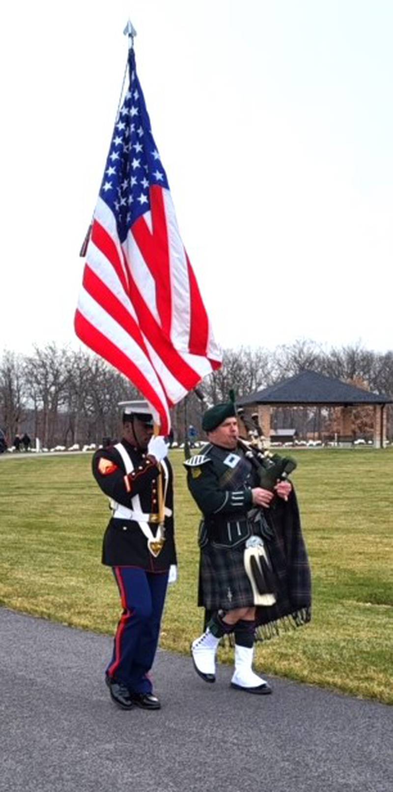During the wreath placement, a Trooping of Colors was conducted by the Marine Corps Color Bearer and the Lone Piper.