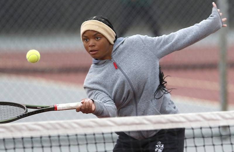 Fenwick’s Trinity Hardin returns the ball Thursday, Oct. 20, 2022, during during the first day of the IHSA State Girls Tennis Tournament at Schaumburg High School in Schaumburg.