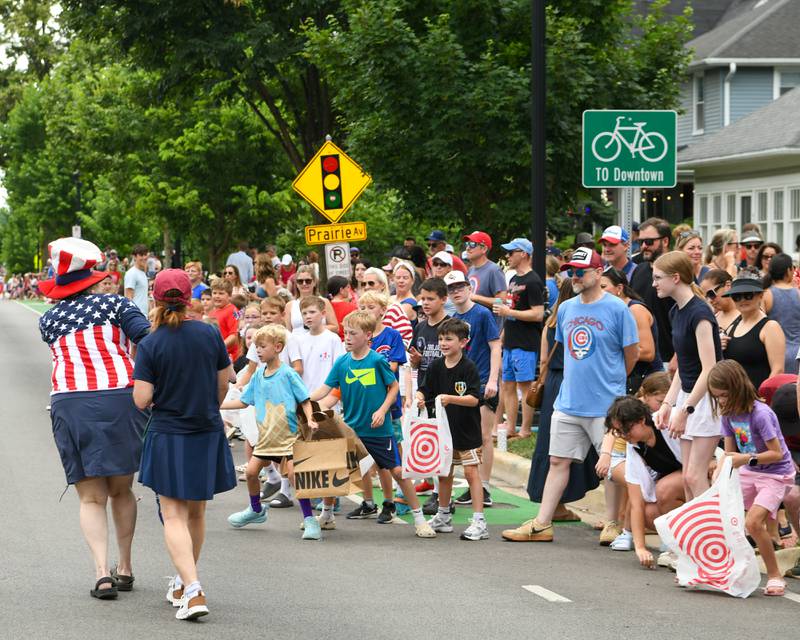 Young community members are anxiously awaiting candy during the Independence Day parade on Friday July 4, 2025, in Downtown Downers Grove.