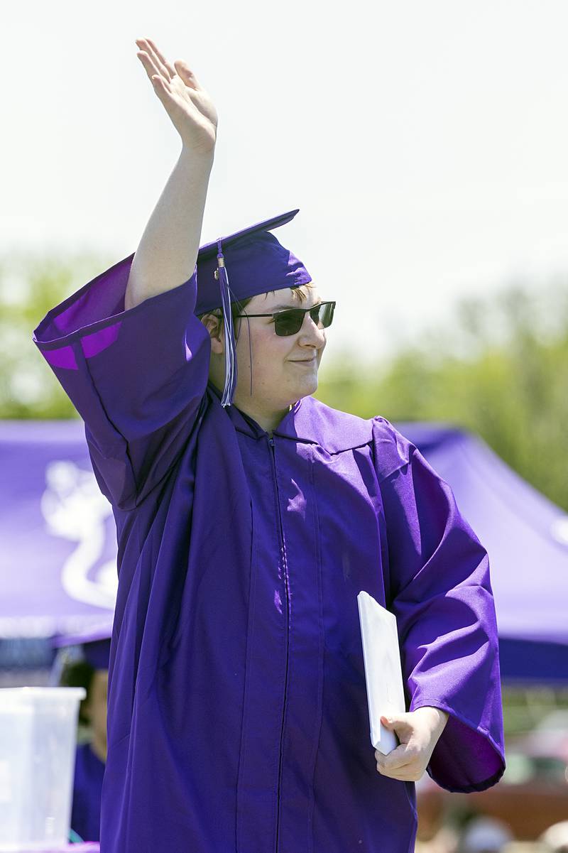 Alexander Pierce waves to the crowd Sunday, May 24, 2026, after receiving his diploma from Dixon High School.