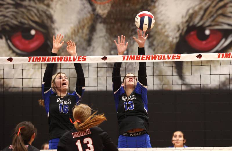 Hinckley-Big Rock's Grace Barrett (left) and Raven Wagner try to block the ball back to the Indian Creek side during their Class 1A regional play-in game Monday, Oct. 28, 2024, at Indian Creek High School in Shabbona.