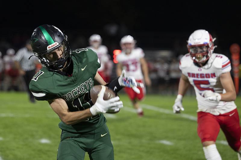 Rock Falls’ Logan Thome hauls in a pass and rumbles in for an early touchdown Friday, October 11, 2024, against Oregon.