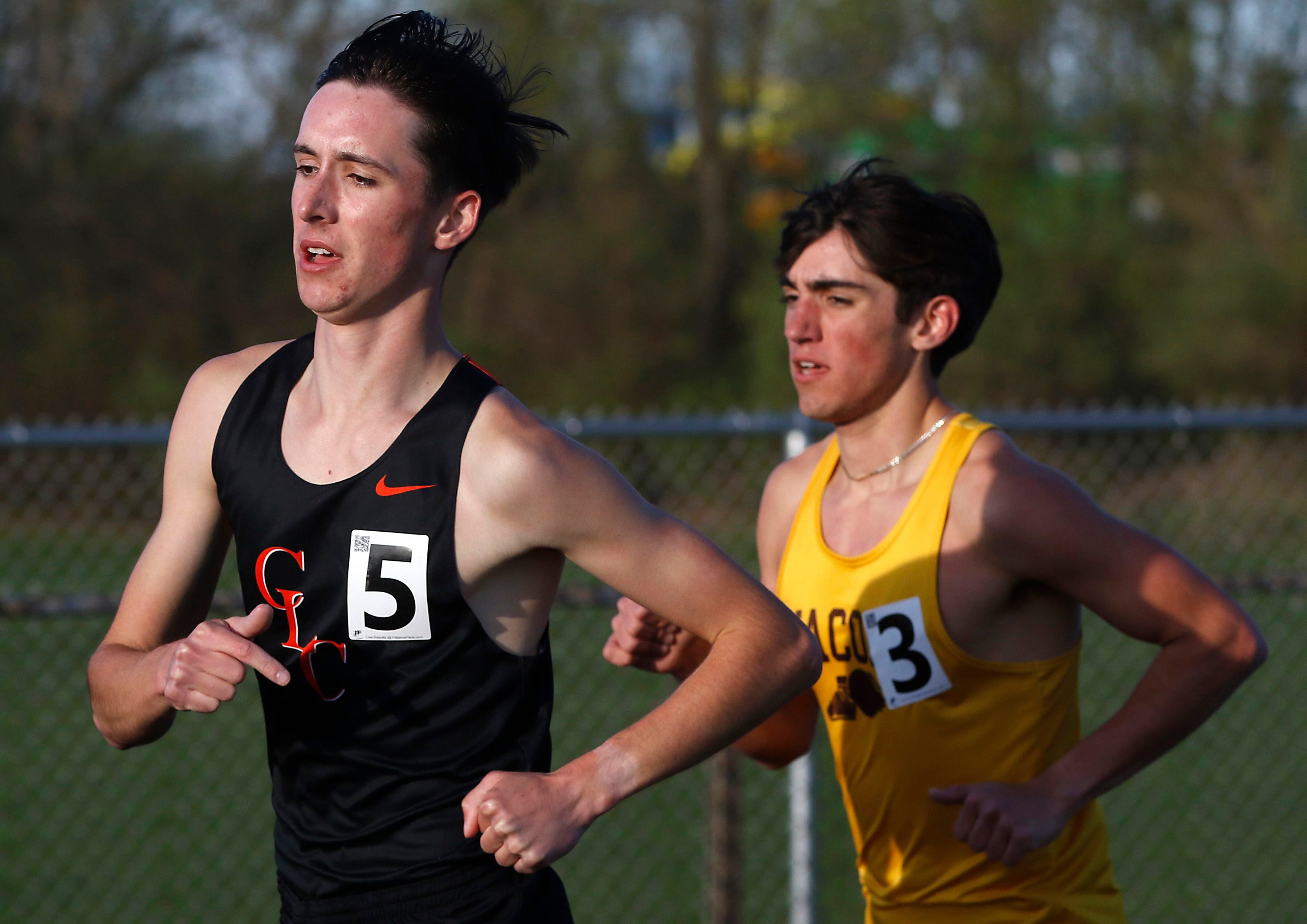 Jacobs’ Matthew Andreano runs off the shoulder of Crystal Lake Central ’s Eddy Klimkowski on his way to winning the 3200 meter run on Friday, April 19, 2024, during the McHenry County Track and Field Meet at Cary-Grove High School.