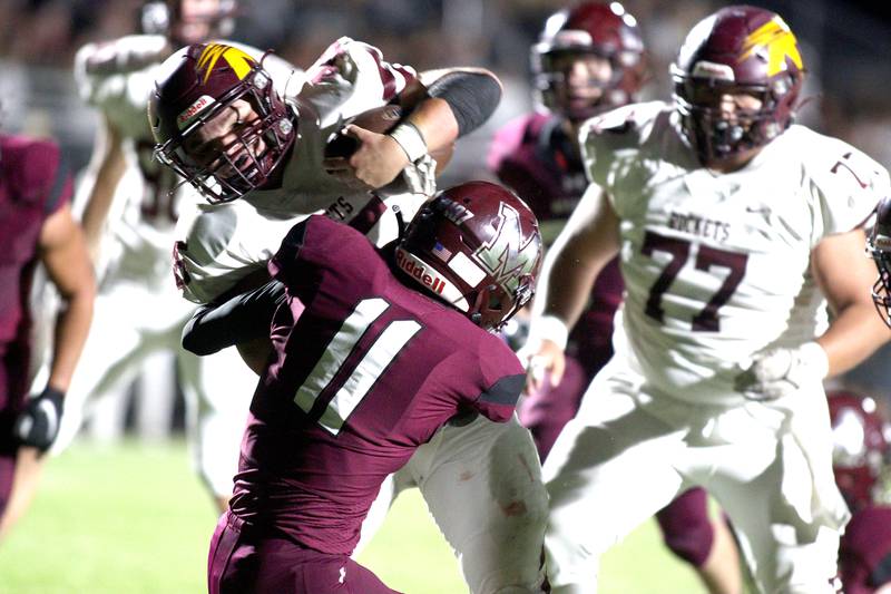 Richmond-Burton’s Braxtin Nellessen breaks through for a touchdown in varsity football at Rod Poppe Field in Marengo Thursday night.