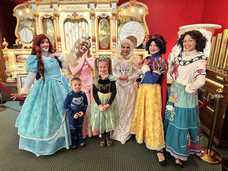 Princesses and a pair of visitors pose for a photo op in the Carousel and Music Hall at the Volo Museum in spring 2023. This year, princesses (and superheroes) once again will entertain museum guests, starting and ending a special week of Spring Break Staycation activities March 23-30.