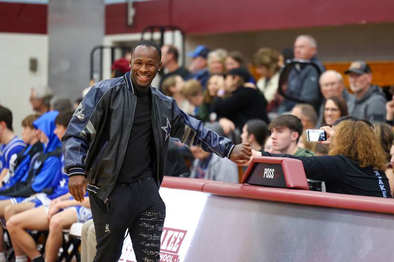 Martavius Laster smiles as he enters the gym to be honored as part of the All-75th Anniversary Team on the opening night of the 75th Kankakee Holiday Tournament on Friday, Dec. 26, 2025