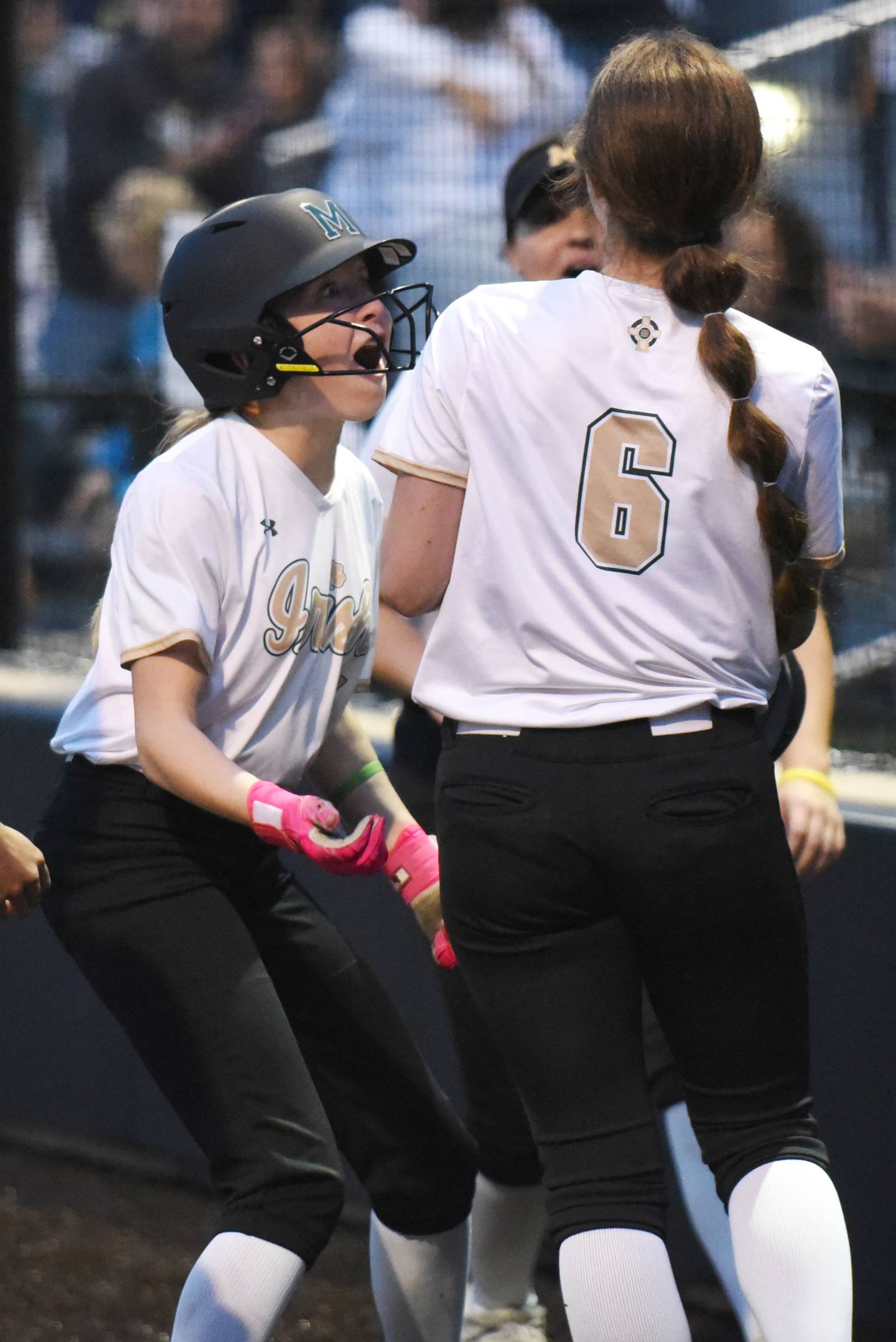 Bishop McNamara's Maddy Weiland, left, congratulates Camille Czako on her go-ahead home run in the ninth inning of the Class 2A Seneca Regional semifinals against Wilmington Tuesday, May 19, 2026.