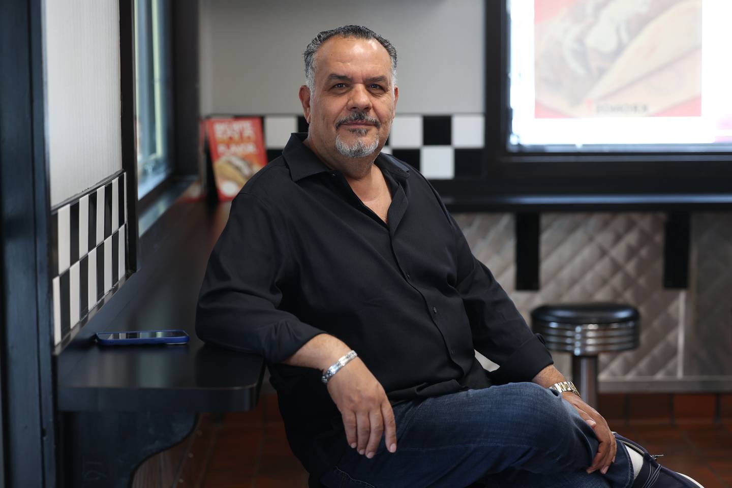 Mario Allabadi, owner of Sub Dock, sits for a photo at his restaurant in Joliet.