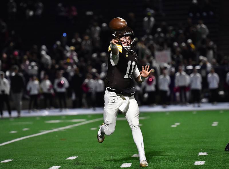 Joliet Catholic's Lucas Simulick (11) passes the ball during the conference game against Providence Catholic on Friday, OCT. 24, 2025, at Joliet.