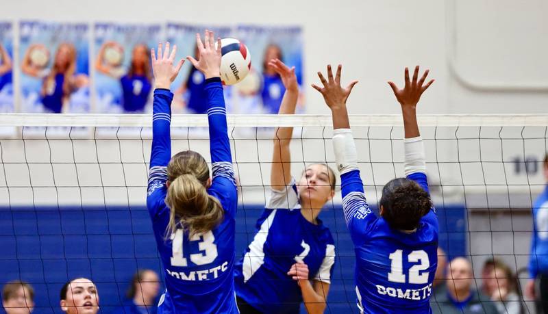 Princeton's Kathy Maciczak takes a hit against Sterling Newman's Kennedi Shippert (13) and Giselle Martin (12) in Thursday's regional finals at Prouty Gym.