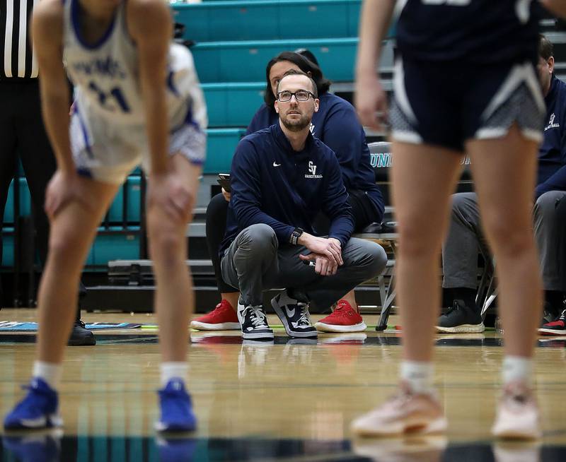 St. Viator Head Coach Kyle Braheny watches as his team shoot a free throw during the IHSA Class 3A Woodstock North Supersectional girls basketball game against Geneva on Monday, March 2, 2026, at Woodstock North High School.