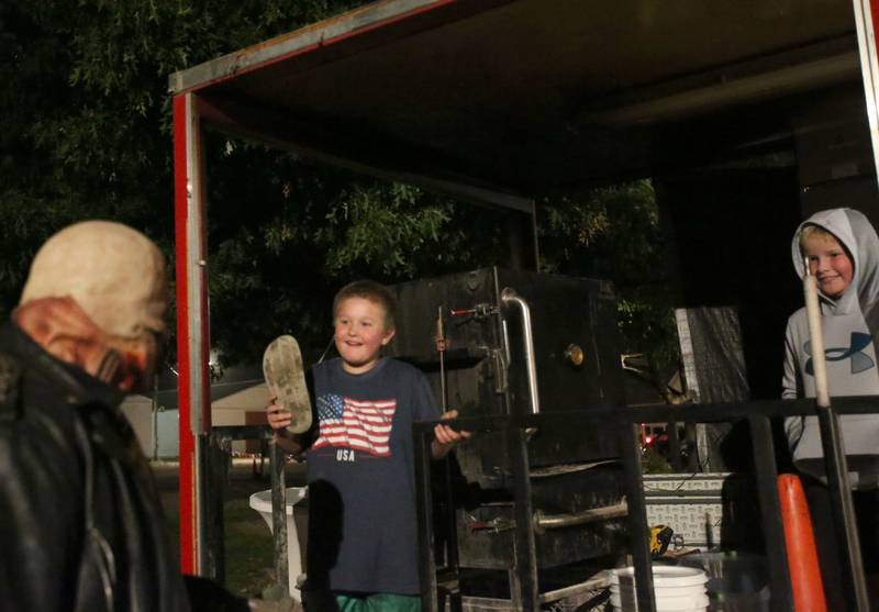 A scary character walks past Jericho Maves of Kewanee and Keegan Prokas of Princeton during the Monster Mash Balloon Bash on Saturday, Oct. 12, 2024 at the Bureau County Fairgrounds in Princeton.