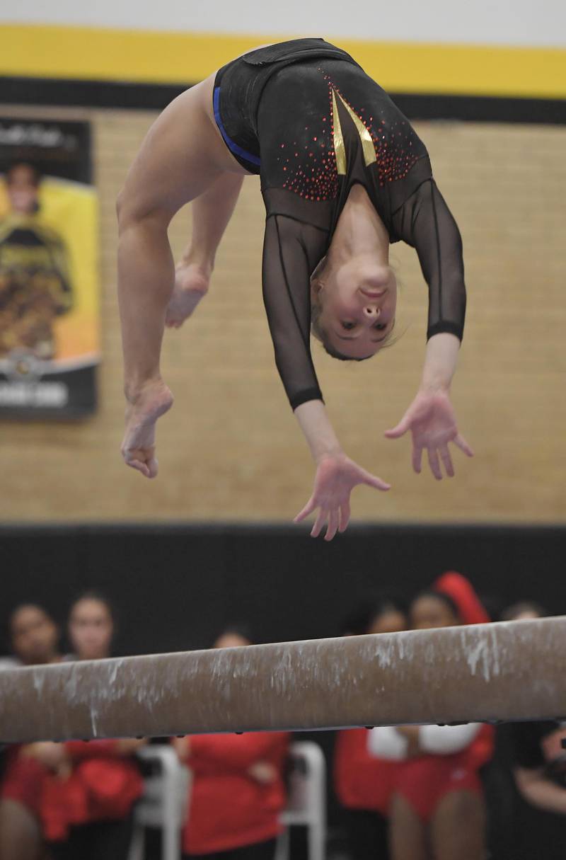 Batavia's Grace Cooper on the balance beam at the Hinsdale South girls gymnastics sectional meet in Darien on Tuesday, February 7, 2023.