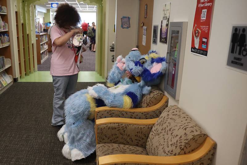 Molly Westbrooke, of Joliet, cools off inside the Lockport Library wearing her hand crafted self-made Sky character outfit at Comicolopis, Lockport’s 7th annual Comic and Fandom Con on Saturday, July 29.