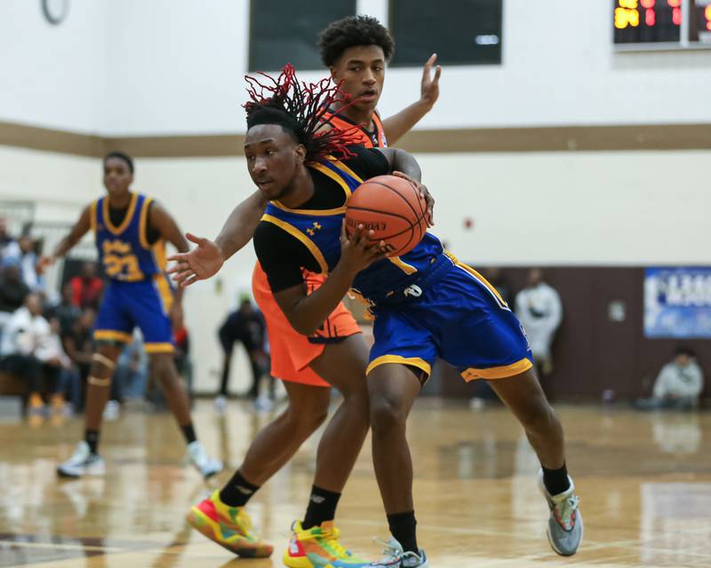 Joliet Central's JaMarcho Holman (1) spins away from Romeoville's Mickeis Johnson (1) in the WJOL Tournament Championship game. Nov 25, 2023.