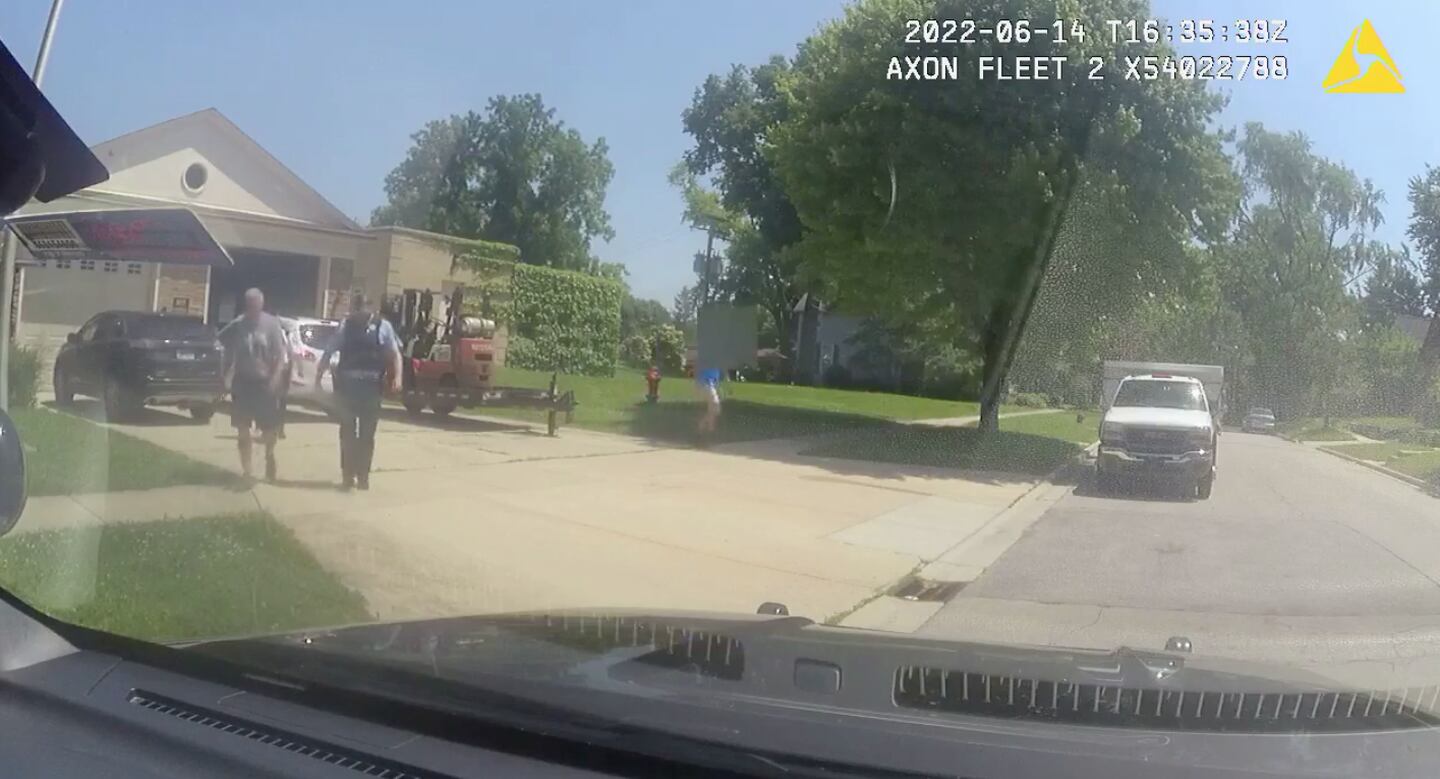 Squad vehicle video of Joliet police officers leading former Joliet police Sgt. Dwayne Killian (left) to a squad vehicle during his arrest on June 14, 2022.