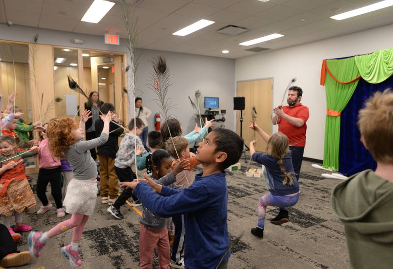 Children including Matias Roney of Wheaton practice balancing with a feather during the See a Juggler, Be a Juggler held at the Glen Ellyn Library Saturday April 5, 2025.