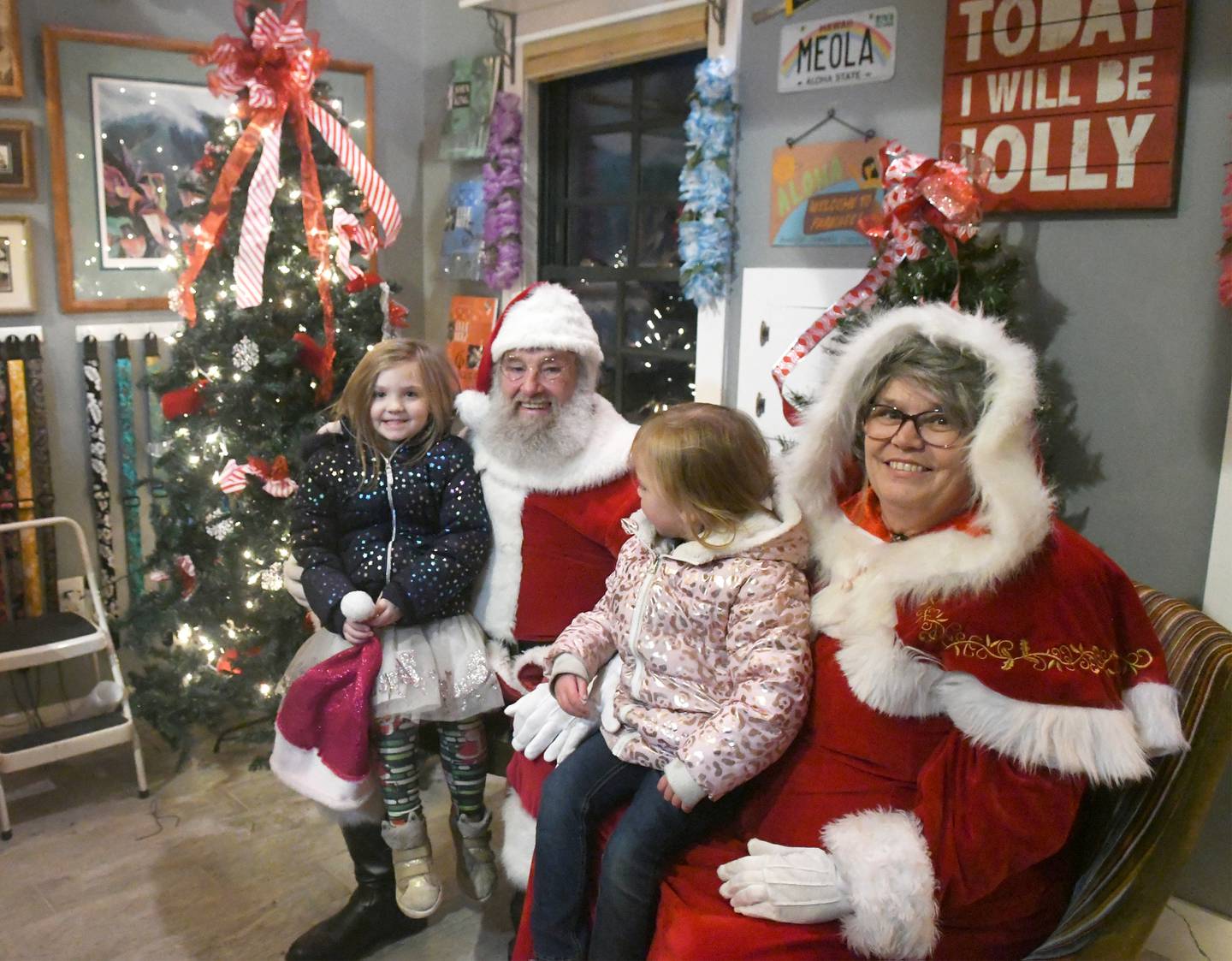 Aurora Mills, 5, and Mia Flaharty, 3, visited with Santa and Mrs. Claus at the Ukele Station in Oregon during Oregon's Candlelight Walk on Nov. 26.