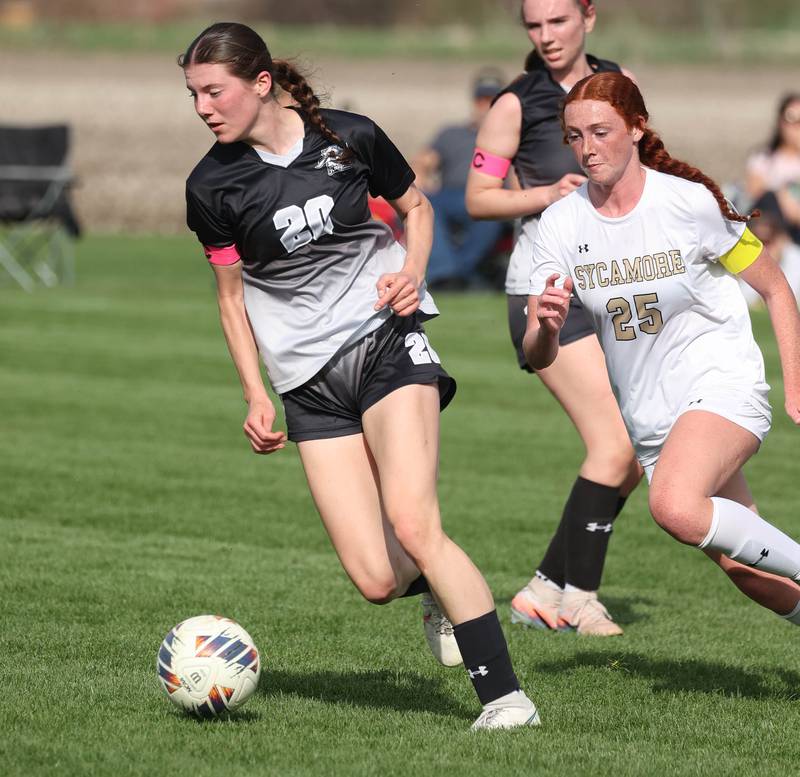 Kaneland's Erin Doucette pushes the ball ahead of Sycamore's Isabelle Segreti during their game Monday, April 13, 2026, at Kaneland High School.