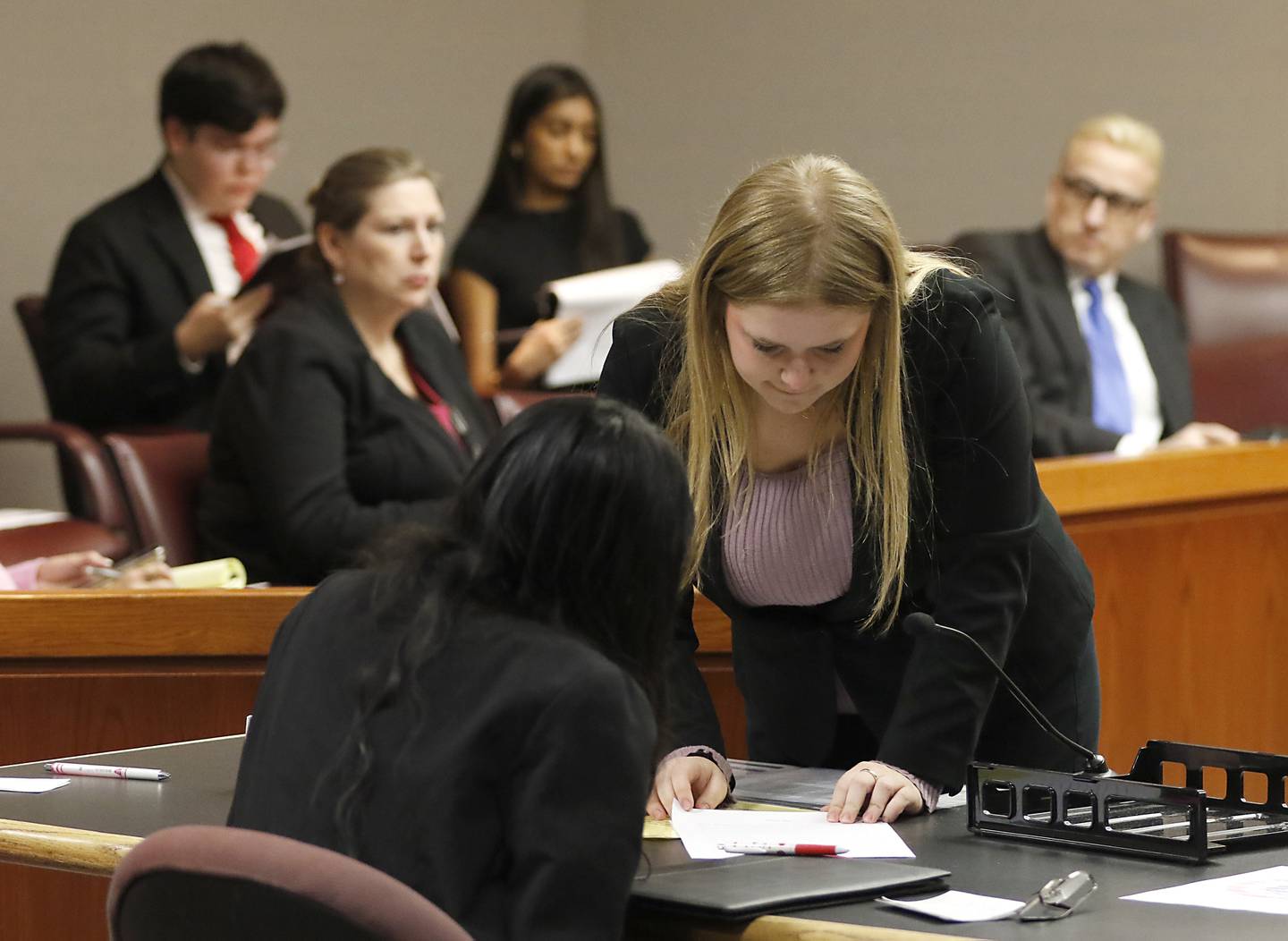 Huntley's Sydney Sullivan confers with her teammate, Navjot Khaira, as she questions a witness during the 2025 McHenry County Mock Trial Open on Friday, Feb. 14, 2025, at the McHenry County Courthouse in Woodstock.