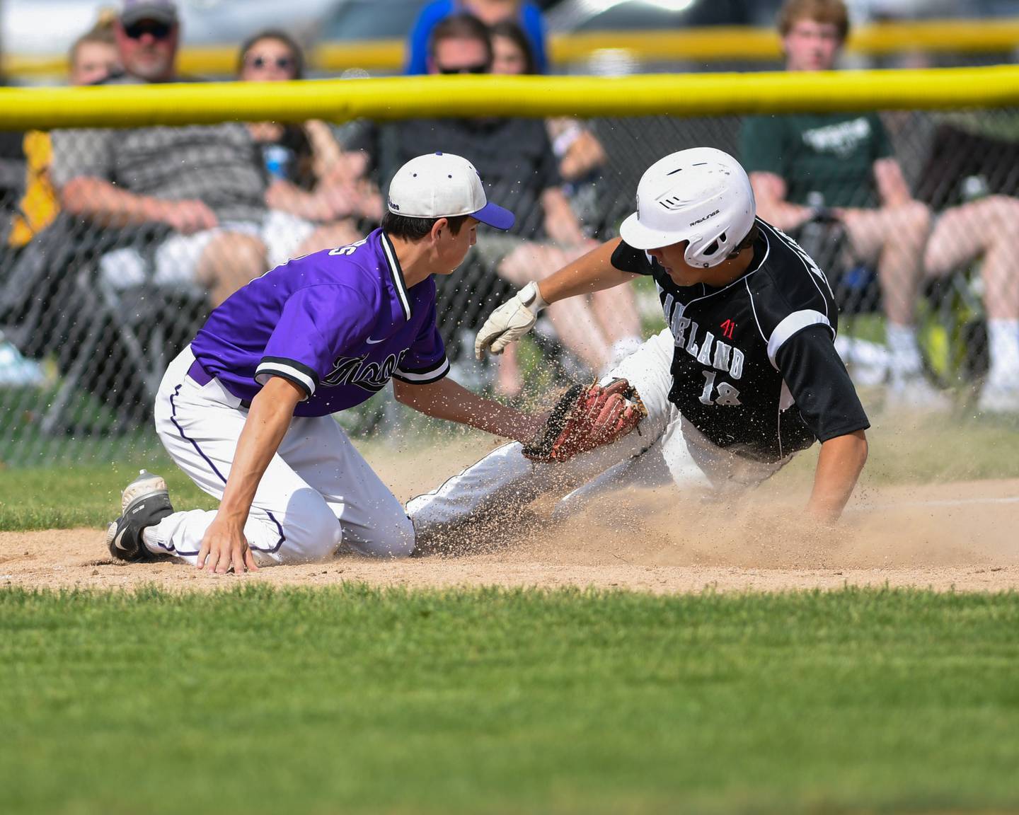 Dixon's Alex Harrison tries to take out Kaneland Collin Miller (18)  as he stole third during the early innings of the game and was called safe on Wednesday, June 1st, held in Sycamore for a sectional playoff game.