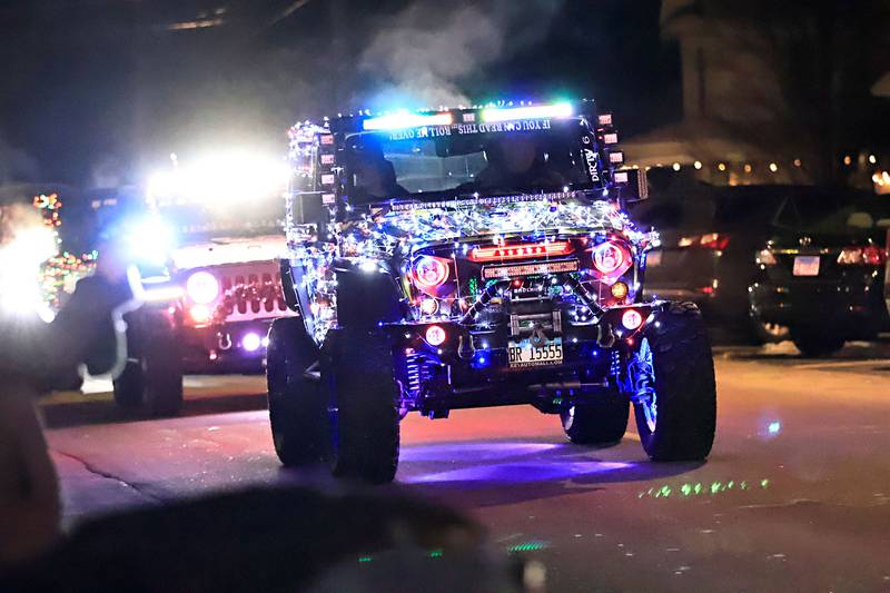 Chris Sperry lit up the night Saturday with the QC Freedom Crawlers in the annual Christmas Parade in Erie on Saturday, Dec. 7, 2025.