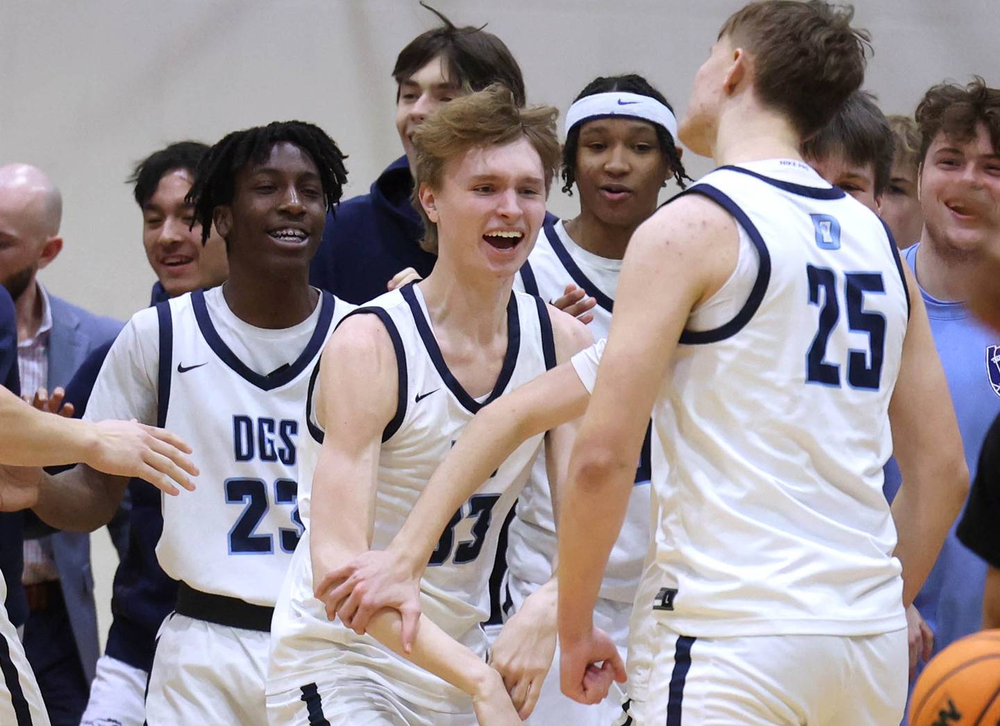 The Downers Grove bench celebrates after a dunk by Daniel Sveiteris (right) causes Proviso East to call a time out during their game Friday, Feb. 14, 2025, at Downers Grove South High School.