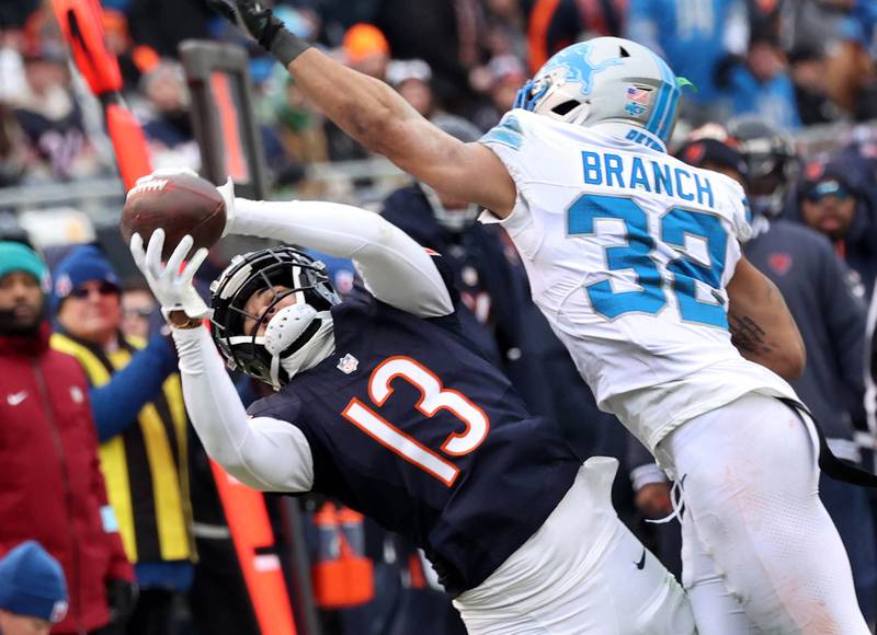 Chicago Bears wide receiver Keenan Allen makes a catch despite the coverage of Detroit Lions safety Brian Branch during their game Sunday, Dec. 22, 2024, at Soldier Field in Chicago.
