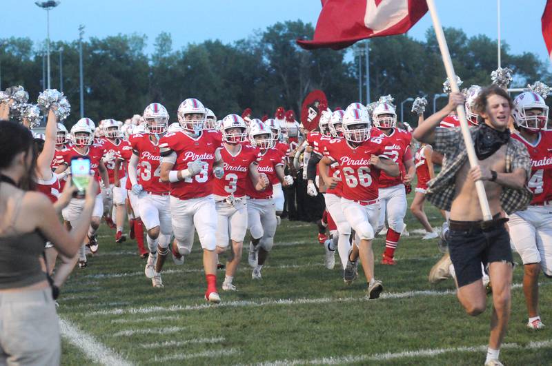 The Ottawa football team runs onto the field before the Ottawa home game at King Field on Friday, Sept. 15, 2023.