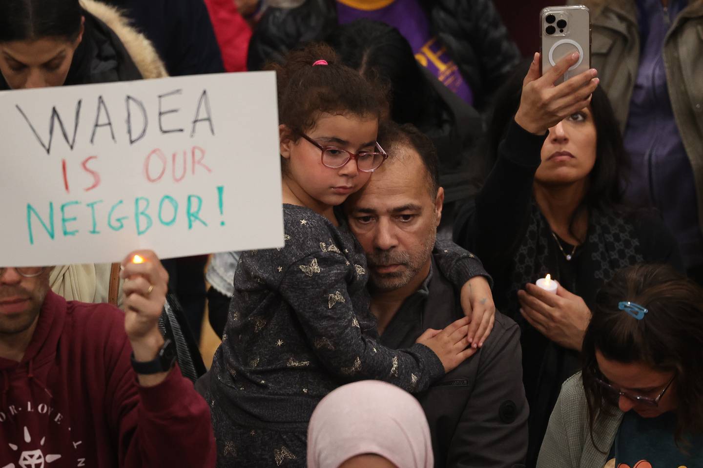 A little girl is held by her father at a vigil for Wadea Al-Fayoume at Prairie Activity & Recreation Center on Tuesday, Oct. 17, 2023 in Plainfield.