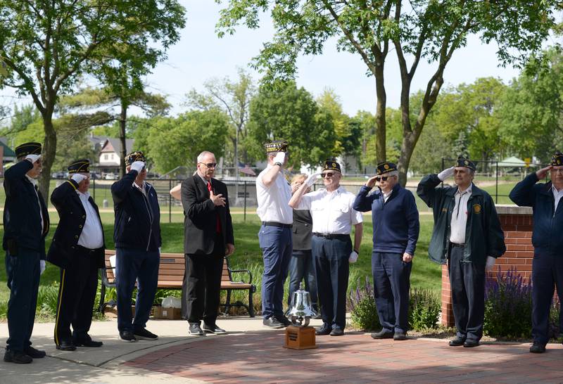 La Grange Park American Legion Post 1941 members as well as the Village President  honor the flag while the Sounding of Taps is performed during the Memorial Day ceremony held at Veterans Memorial Park Monday May 26, 2025.