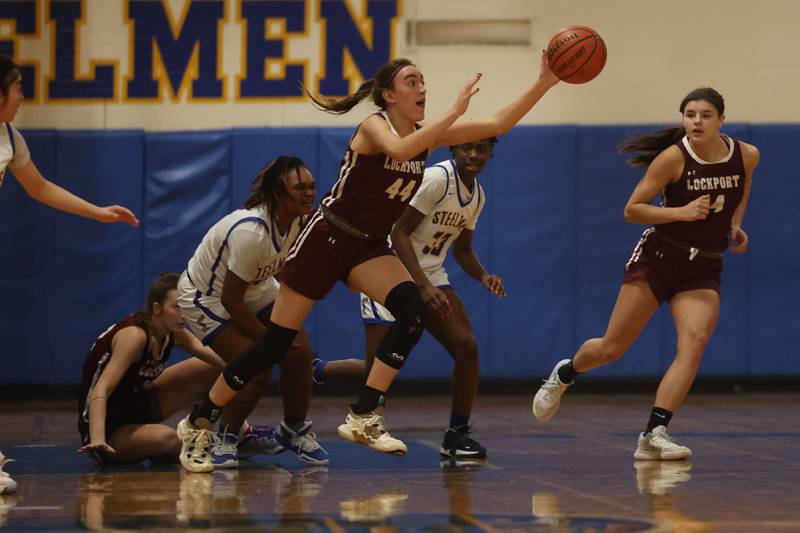 Lockport’s Alaina Peetz recovers the loose ball against Joliet Central.